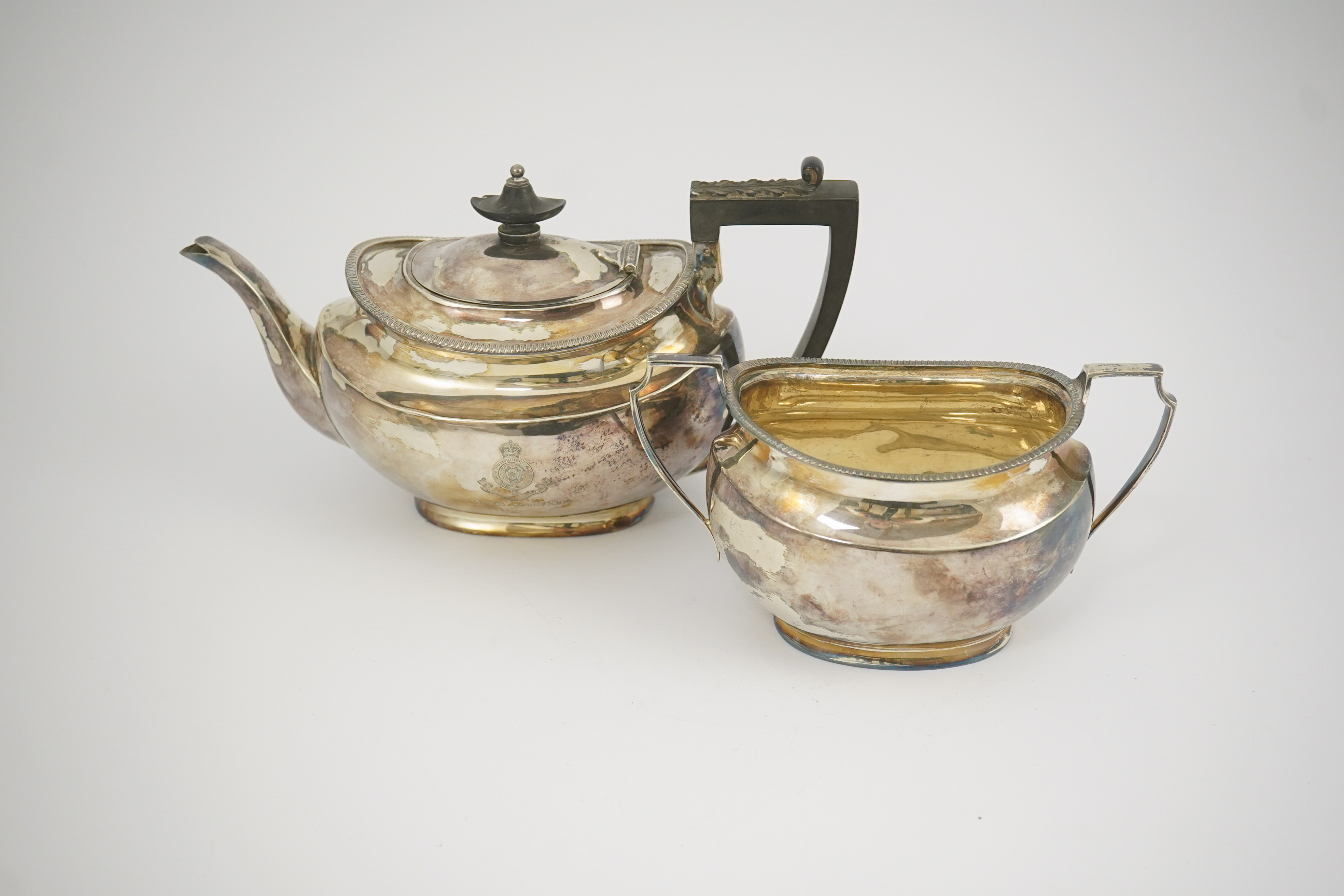 An Edwardian silver teapot and a matching sugar bowl, with engraved inscription, relating to the Royal Fusiliers, by Atkin Brothers